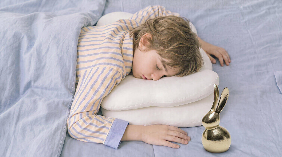 A stomach sleeper resting on a pillow
